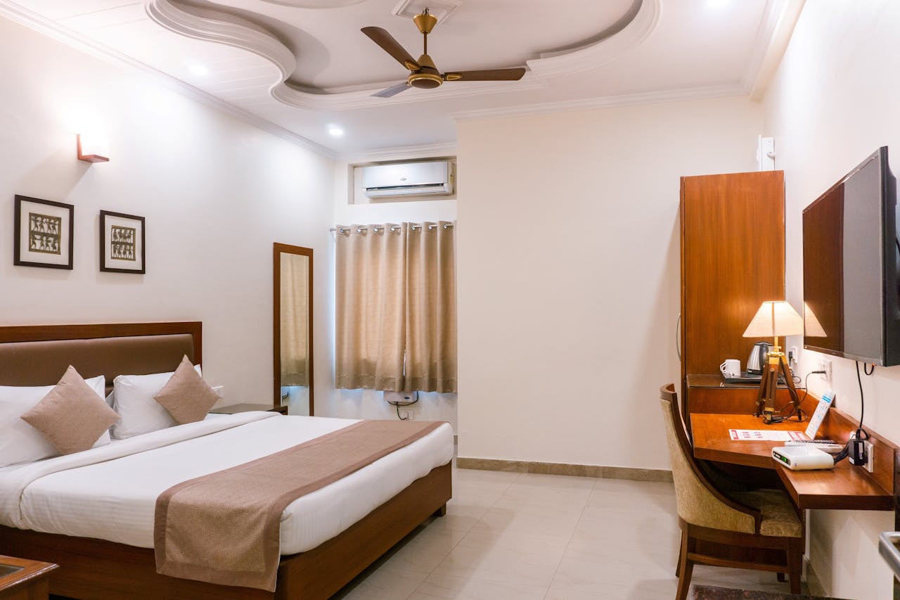 who-we-are Comfortable hotel room featuring modern interior design with wooden furniture and soft lighting.