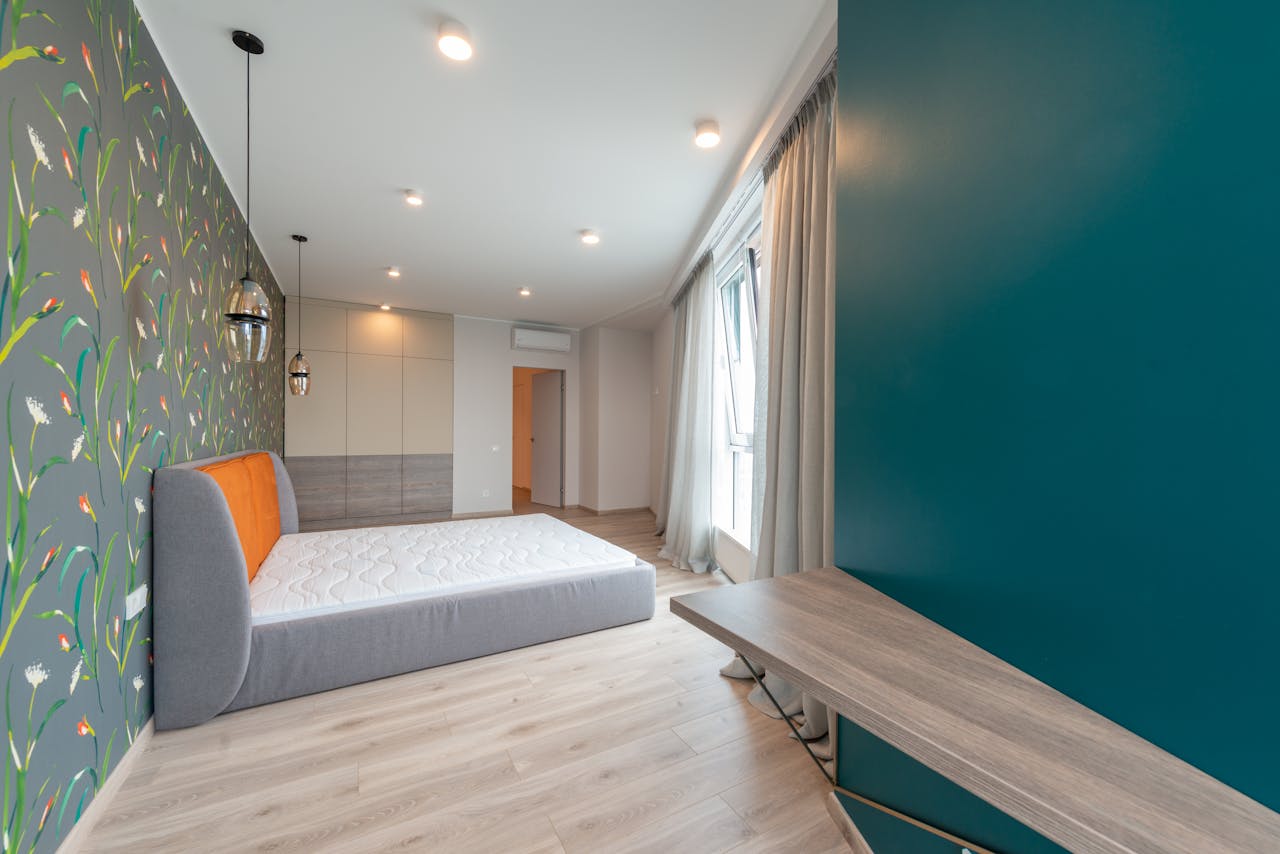 services-01 Contemporary bedroom interior featuring vibrant floral wallpaper and minimal furniture.